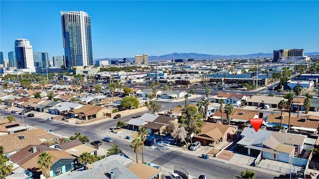 view of property location with nearby urban area and a mountain backdrop