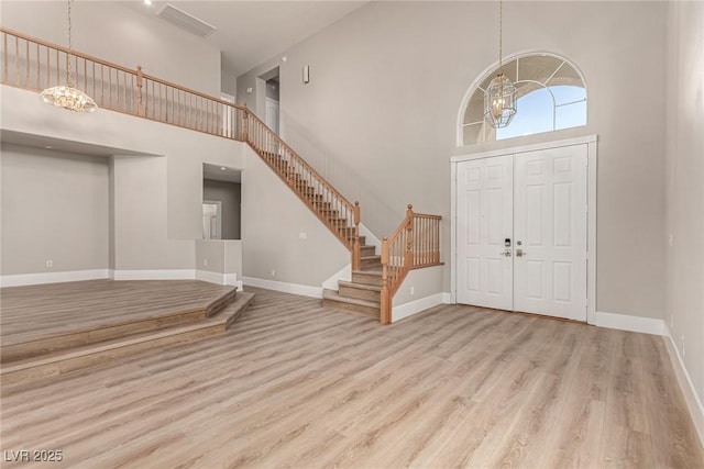 432 Emerald Heights St, Las Vegas, NV 89144 - foyer entrance with a chandelier, a high ceiling, wood finished floors, stairs, and baseboards