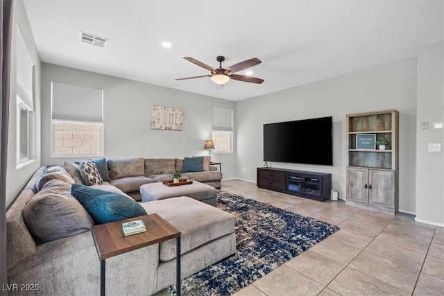 tiled living room featuring a ceiling fan, baseboards, and recessed lighting