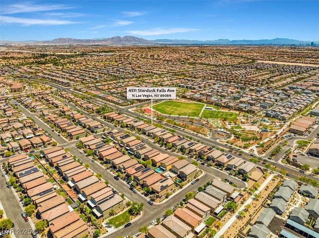 aerial overview of property's location featuring a mountainous background and nearby suburban area