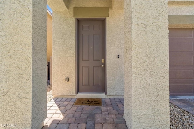 doorway to property with stucco siding