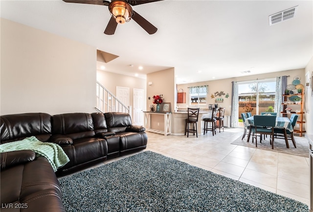 living area with a ceiling fan, light tile patterned flooring, stairway, and recessed lighting