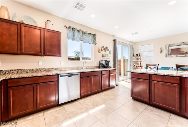 kitchen featuring stainless steel dishwasher, a sink, light tile patterned flooring, light stone countertops, and recessed lighting