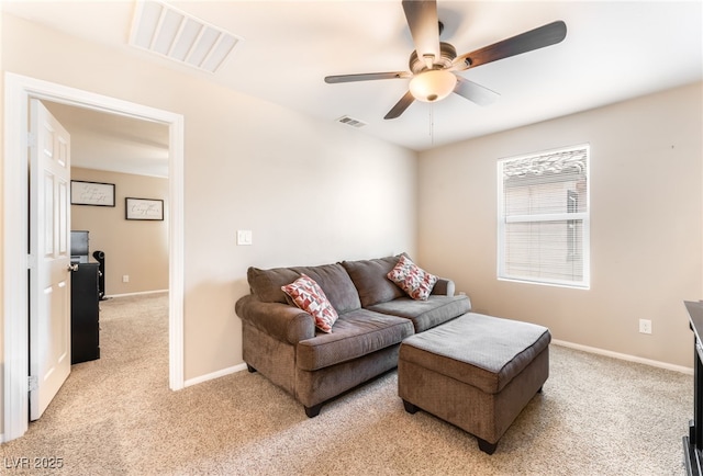living room featuring light carpet, a ceiling fan, and baseboards