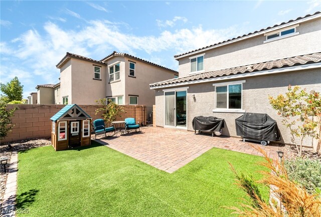 back of property featuring stucco siding, a tile roof, and a patio