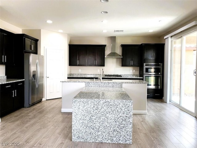 7861 Hamilton Pool Dr, Las Vegas, NV 89113 - kitchen with appliances with stainless steel finishes, wall chimney range hood, plenty of natural light, a sink, and recessed lighting