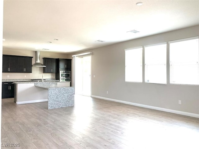 7861 Hamilton Pool Dr, Las Vegas, NV 89113 - unfurnished living room featuring baseboards and light wood finished floors