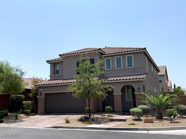 7861 Hamilton Pool Dr, Las Vegas, NV 89113 - mediterranean / spanish home featuring a garage, stucco siding, decorative driveway, and a tiled roof