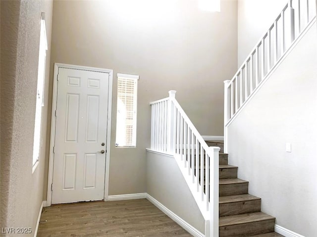 7861 Hamilton Pool Dr, Las Vegas, NV 89113 - entryway with a high ceiling, wood finished floors, stairs, and baseboards
