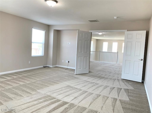 7861 Hamilton Pool Dr, Las Vegas, NV 89113 - empty room featuring light carpet, healthy amount of natural light, and baseboards