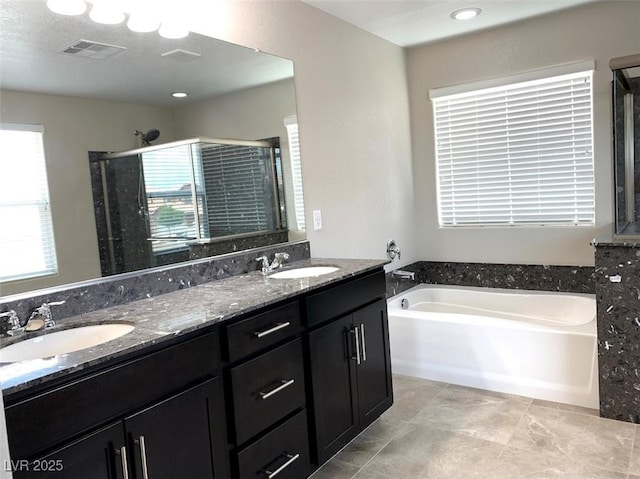 7861 Hamilton Pool Dr, Las Vegas, NV 89113 - full bath featuring a stall shower, a bath, and double vanity