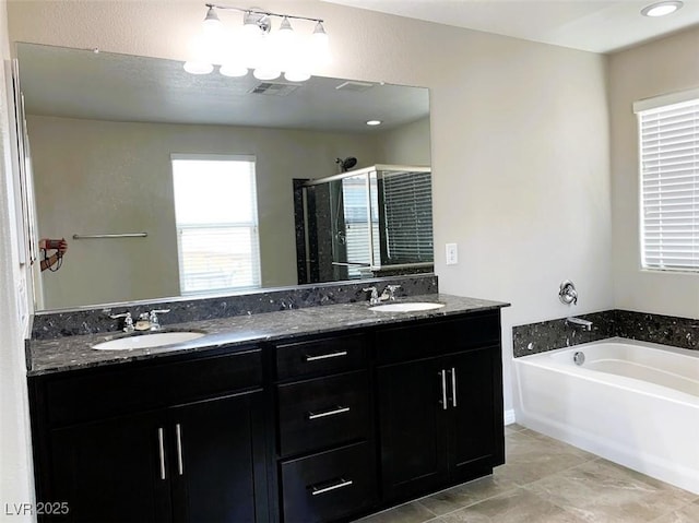 7861 Hamilton Pool Dr, Las Vegas, NV 89113 - full bathroom featuring double vanity, a stall shower, and a bath
