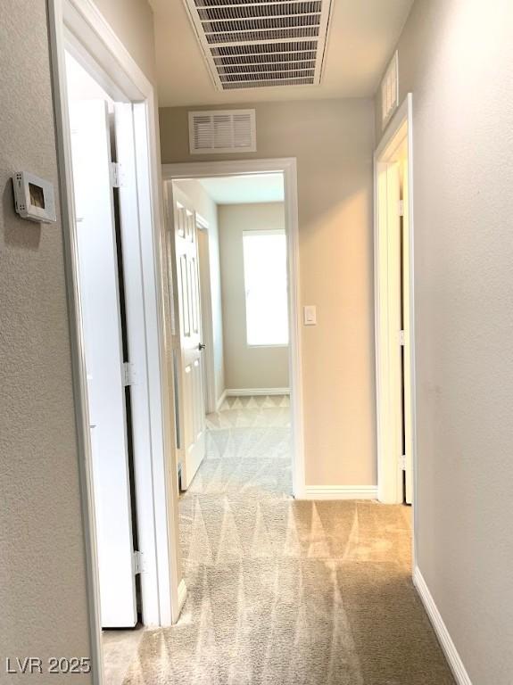 7861 Hamilton Pool Dr, Las Vegas, NV 89113 - corridor featuring light carpet and baseboards