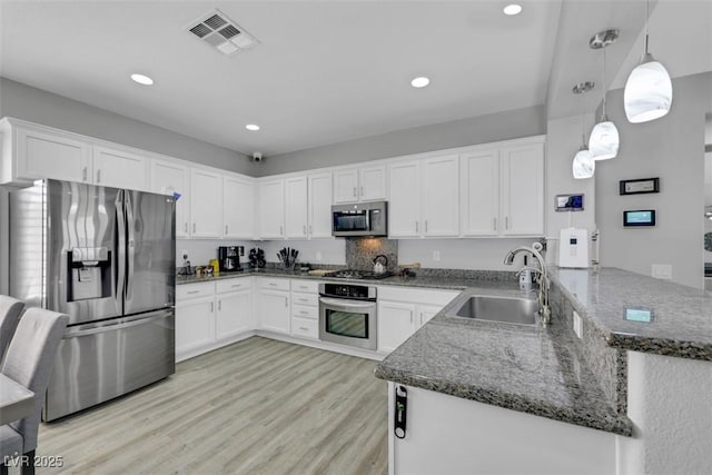 8836 Martin Downs Pl, Las Vegas, NV 89131 - kitchen featuring stainless steel appliances, a sink, a peninsula, white cabinets, and recessed lighting
