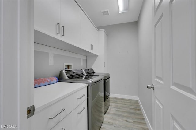 8836 Martin Downs Pl, Las Vegas, NV 89131 - washroom with washer and clothes dryer, light wood-style flooring, baseboards, and cabinet space