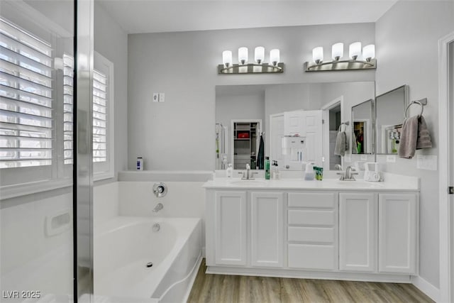 8836 Martin Downs Pl, Las Vegas, NV 89131 - bathroom with a bath, wood finished floors, and double vanity