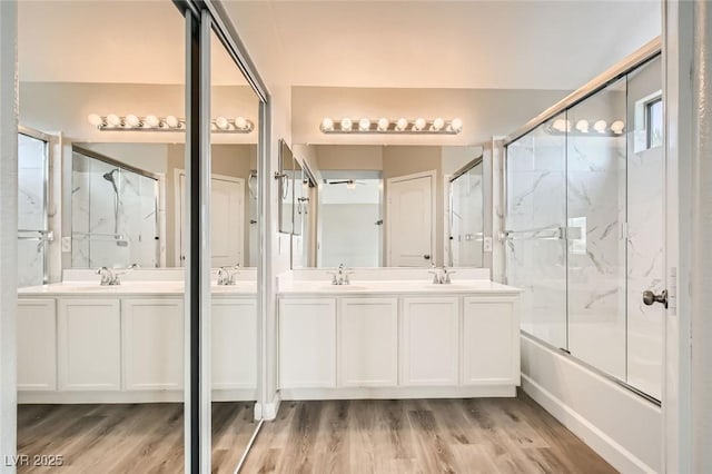 8469 Cheerful Brook Ave, Las Vegas, NV 89143 - bathroom with double vanity, wood finished floors, and bath / shower combo with glass door