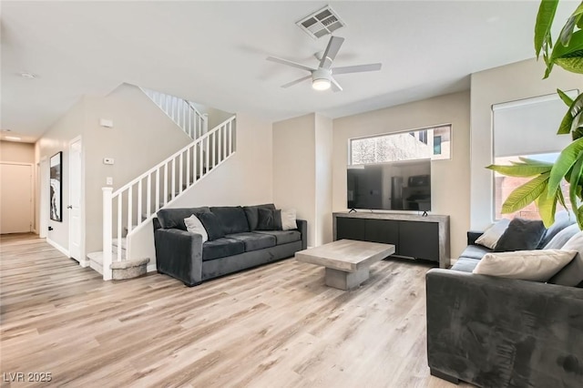 8469 Cheerful Brook Ave, Las Vegas, NV 89143 - living room featuring light wood-style flooring, stairway, and a ceiling fan
