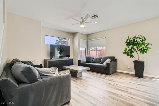 8469 Cheerful Brook Ave, Las Vegas, NV 89143 - living room featuring light wood finished floors, plenty of natural light, and a ceiling fan