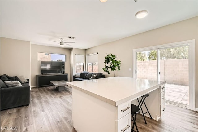 8469 Cheerful Brook Ave, Las Vegas, NV 89143 - office space with healthy amount of natural light, light wood-type flooring, ceiling fan, and baseboards