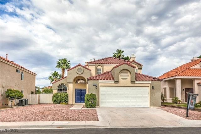 2107 Fountain Springs Dr, Henderson, NV 89074 - mediterranean / spanish house featuring stucco siding, a garage, a tile roof, and driveway