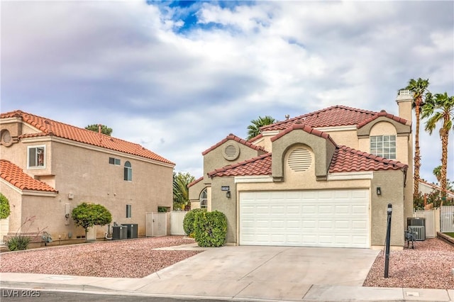 2107 Fountain Springs Dr, Henderson, NV 89074 - mediterranean / spanish house with concrete driveway, an attached garage, cooling unit, a gate, and stucco siding