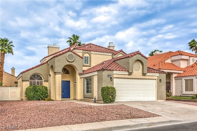 2107 Fountain Springs Dr, Henderson, NV 89074 - mediterranean / spanish home with driveway, a garage, a chimney, and stucco siding