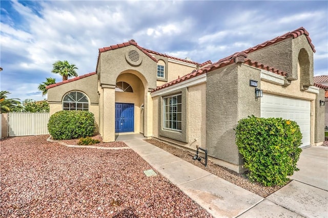 2107 Fountain Springs Dr, Henderson, NV 89074 - mediterranean / spanish-style house featuring stucco siding, a tiled roof, and a garage