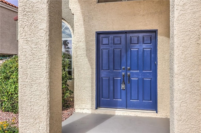 2107 Fountain Springs Dr, Henderson, NV 89074 - view of exterior entry featuring stucco siding and french doors