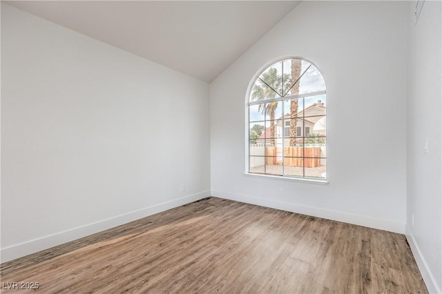 2107 Fountain Springs Dr, Henderson, NV 89074 - spare room with wood finished floors, baseboards, and lofted ceiling