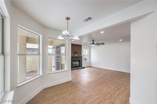 2107 Fountain Springs Dr, Henderson, NV 89074 - unfurnished living room featuring recessed lighting, light wood finished floors, a brick fireplace, baseboards, and a chandelier