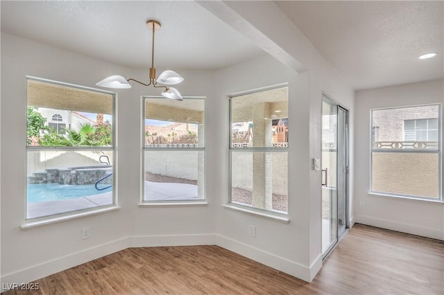 2107 Fountain Springs Dr, Henderson, NV 89074 - unfurnished dining area featuring healthy amount of natural light, a chandelier, and wood finished floors