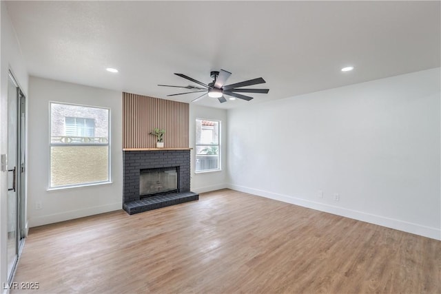 2107 Fountain Springs Dr, Henderson, NV 89074 - unfurnished living room with light wood-type flooring, baseboards, a ceiling fan, a brick fireplace, and recessed lighting
