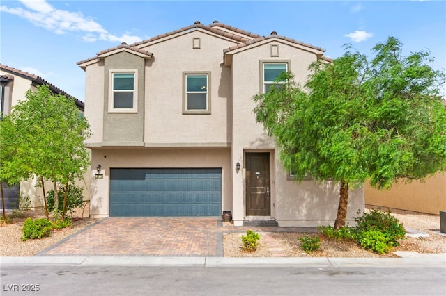 2672 Painted Mist Ct, Las Vegas, NV 89142 - view of front of property featuring stucco siding, a tiled roof, a garage, and decorative driveway