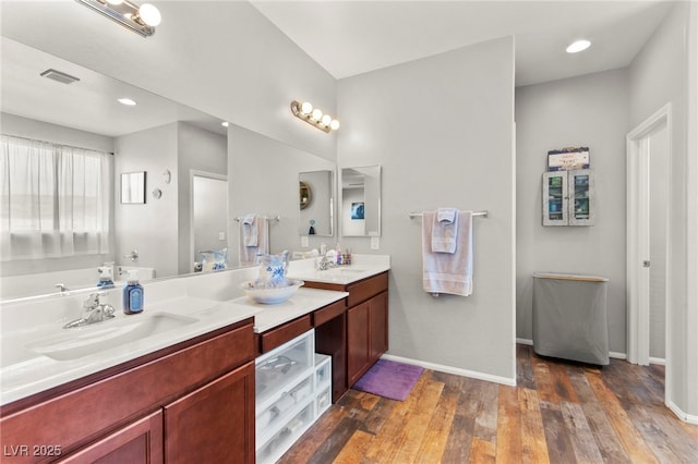 2672 Painted Mist Ct, Las Vegas, NV 89142 - bathroom with double vanity, baseboards, wood-type flooring, and recessed lighting