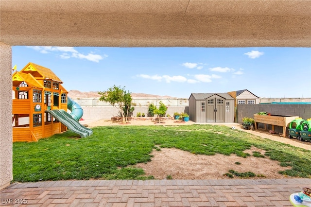 2672 Painted Mist Ct, Las Vegas, NV 89142 - view of yard featuring a storage unit, an outdoor structure, and a playground