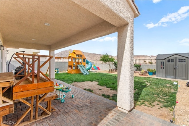 2672 Painted Mist Ct, Las Vegas, NV 89142 - view of patio / terrace with a shed, an outdoor structure, and a playground