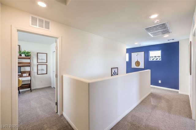 hallway featuring carpet, an upstairs landing, recessed lighting, and baseboards