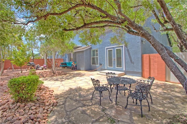 view of patio with french doors and a fenced backyard