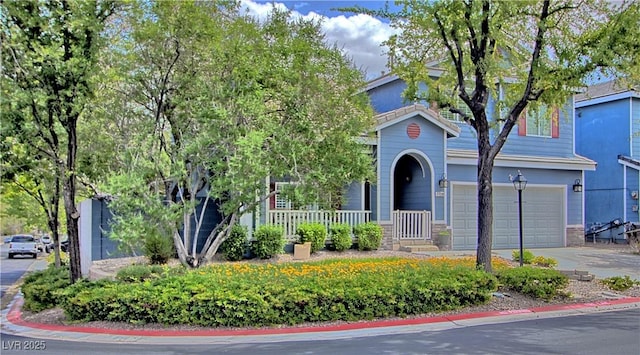 7728 Whispering River St, Las Vegas, NV 89131 - obstructed view of property featuring an attached garage, driveway, and a porch