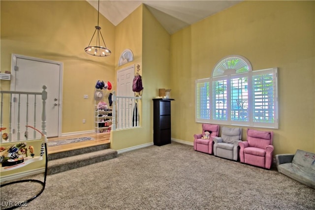 game room with high vaulted ceiling, carpet, a chandelier, and baseboards