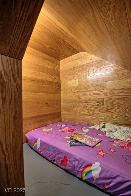 bedroom featuring wooden walls