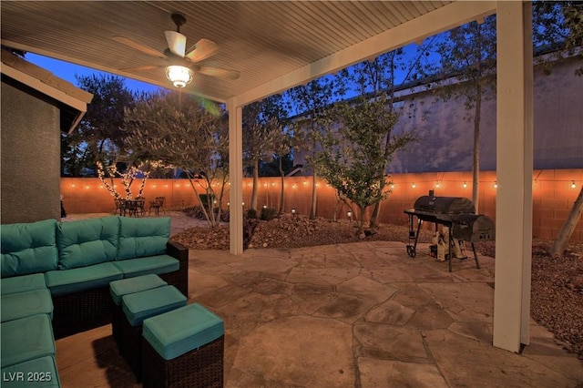 7728 Whispering River St, Las Vegas, NV 89131 - patio at night featuring an outdoor hangout area, area for grilling, a patio, ceiling fan, and a fenced backyard