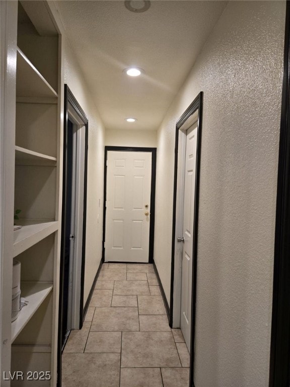 6361 Copperfield Ave, Las Vegas, NV 89108 - hall with light tile patterned floors, a textured wall, and recessed lighting
