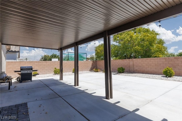 view of patio with area for grilling and a fenced backyard