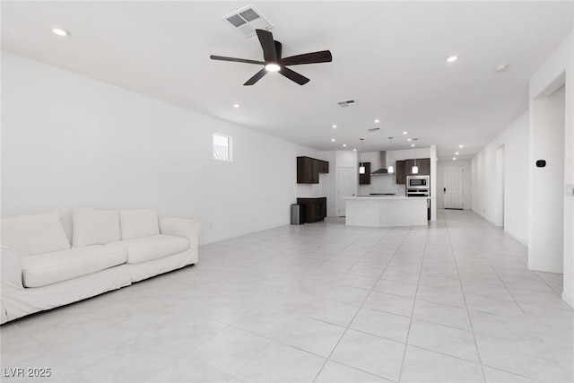 living area featuring recessed lighting and a ceiling fan