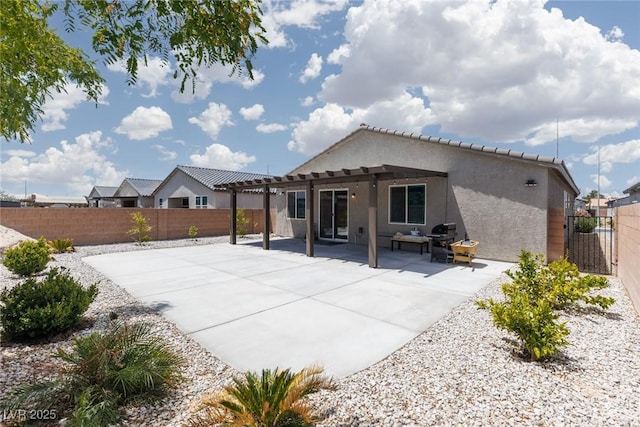 back of house featuring a pergola, stucco siding, a fenced backyard, and a patio area