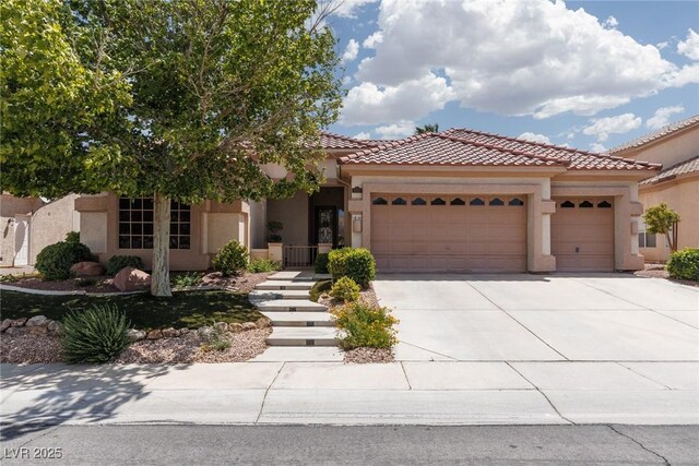 3522 Shonna Way N, Las Vegas, NV 89032 - mediterranean / spanish house with a garage, stucco siding, concrete driveway, and a tiled roof
