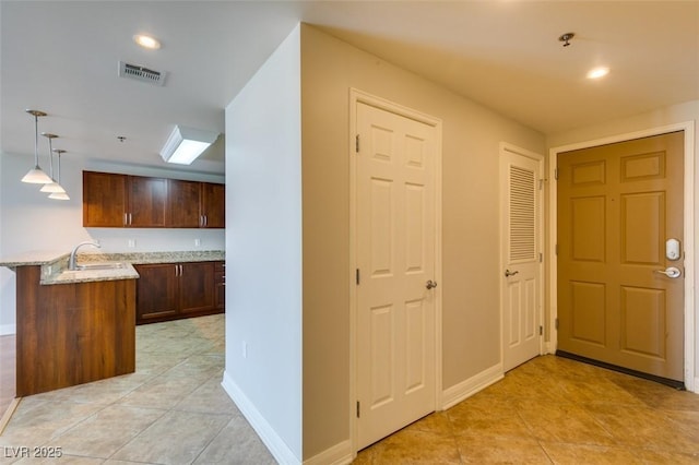 150 Las Vegas Blvd Unit 2003, Las Vegas, NV 89101 - hallway featuring light tile patterned flooring, baseboards, and a sink