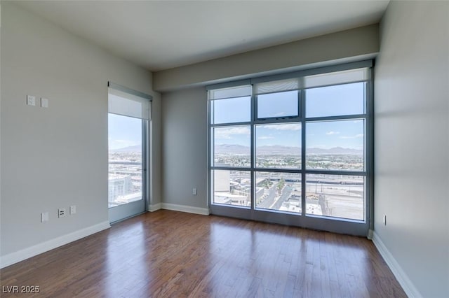 150 Las Vegas Blvd Unit 2003, Las Vegas, NV 89101 - empty room featuring wood finished floors, plenty of natural light, and baseboards